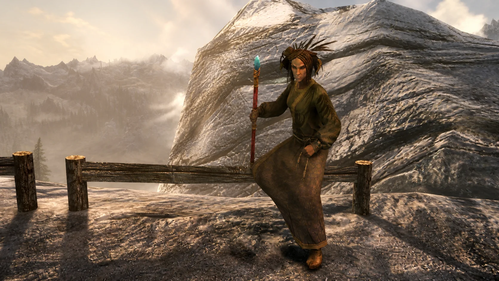 The Wildspeaker carrying her staff along the high snowy trail beside Angi's Camp